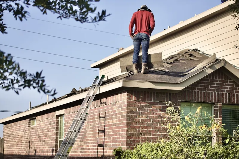 Professional roofer working on a residential roof in Oak Run
